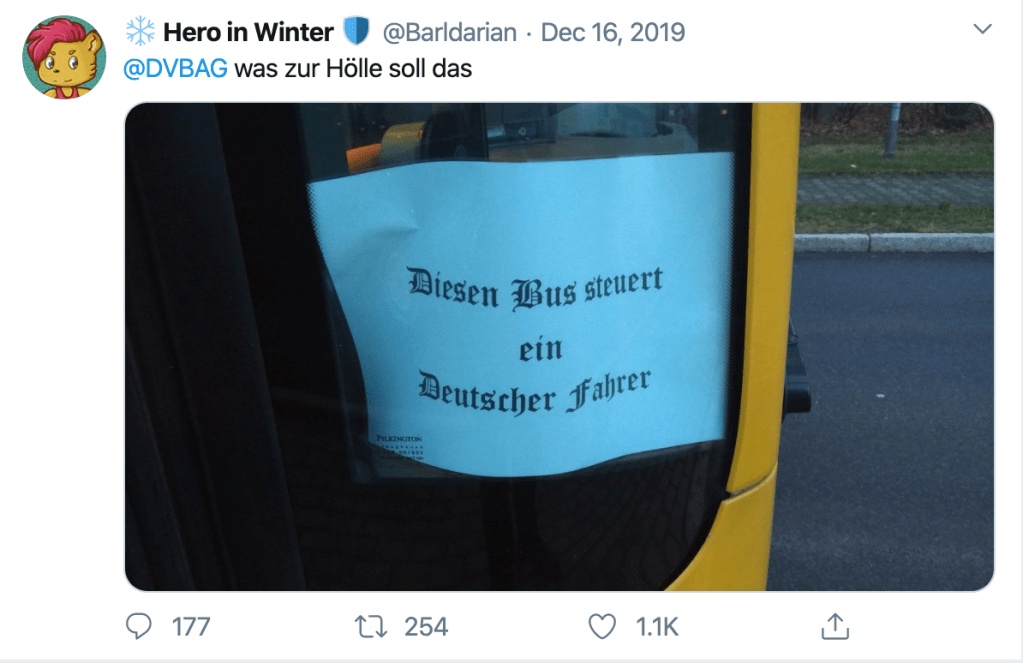 Tweet by @Barldarian, showing a blackletters typeface sign on a bus door reading "This bus is driven by a German driver" 